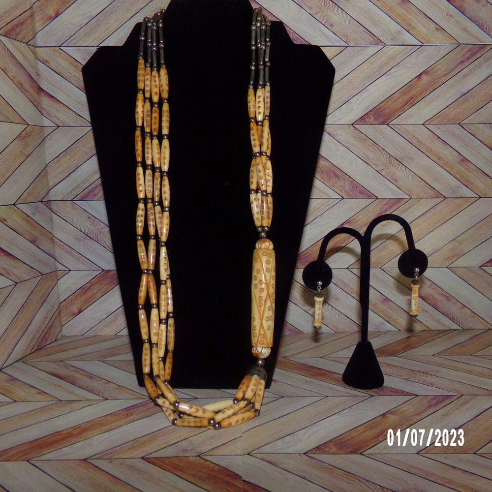 Handmade Asymmetrical carved bone tribal necklace w/ matching carved earrings.